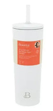 White tumbler with straw and orange info label, small B logo