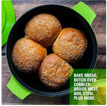 Green Dutch oven with black interior holding five sesame buns, lid resting at side