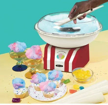 Cotton candy maker with red-and-white base, clear dome, and hand opening lid
