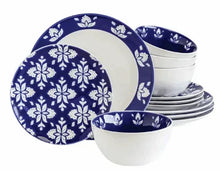 Indigo and white stoneware dinnerware set with floral plates and bowls stacked