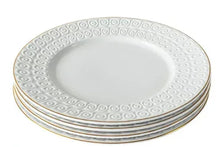 White stoneware dinner plate with embossed swirl border and gold rim