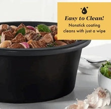 Black slow cooker with visible cooked food inside