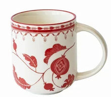Single off-white stoneware mug with red leaf and berry print and curved handle