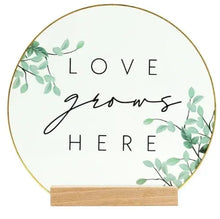Translucent oval tabletop plaque with floral leaf corners, "LOVE" "HERE" on wood base