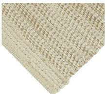 Off-white woven chenille table runner with chunky diagonal weave and corner