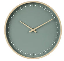 Round indoor analog wall clock with green face, light wood frame, dot minute markers