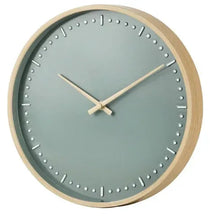 Round indoor analog wall clock with green face, light wood rim, raised dot indices