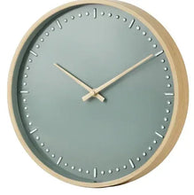 Round indoor analog wall clock with green face, light wood border, long hour and minute hands