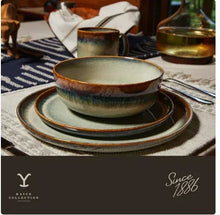 Ceramic oval serving platter on table, speckled teal glaze with brown edge trim