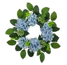 Hydrangea wreath with light blue flowers and green leaves, round floral design.
