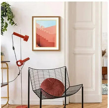 Wood-framed pink stairs wall art print with coral steps and light blue upper area