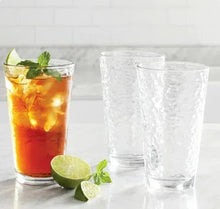 Textured clear drinking glasses, set of 8, one shown with orange drink