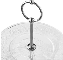 Two-tier glass server top plate with embossed scrolling pattern and metal ring handle.