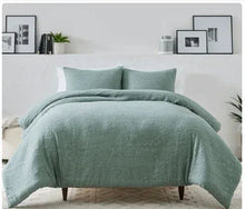 Sage floral comforter set with matching rectangular pillows, layered on a bed