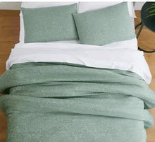 Sage floral comforter set with two square pillows on white bedding