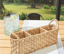 Beige oval rattan caddy with divided compartments for tableware and drinkware