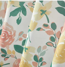 Floral shower curtain fabric close-up with pink roses, yellow flowers, and green leaves