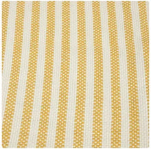 Striped layering rug with yellow and white vertical stripes and woven texture