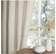 Beige textured curtain panel with vertical weave, draped beside a window