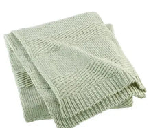 Sage green chenille throw with textured knit and folded edges