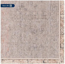Tan area rug close-up with textured abstract pattern and stitched edge