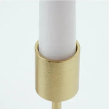 Gold metal tealight candle holder with cylindrical cup and white candle base