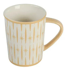 Porcelain mug with retro star pattern, warm tan with gold-toned rim and handle.