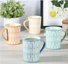 Set of 4 porcelain mugs with retro star pattern in orange, cream, light blue, teal.