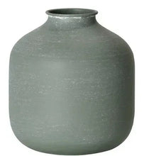 Green metal tabletop vase, wide round body with short neck and textured finish.