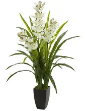 Artificial orchid arrangement with tall green leaves, white flowers, and dark square pot