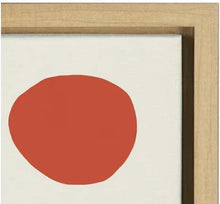 Close-up of framed canvas art with large red circle