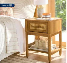 Light honey caned nightstand with woven drawer front and two-tier storage