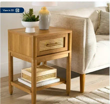 Light honey caned nightstand with rattan-style drawer front and lower shelf