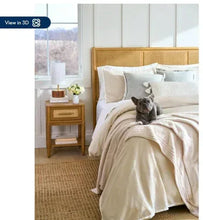 Light honey caned nightstand with drawer and lower open shelf