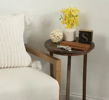 Artificial yellow forsythia flower stems in ribbed off-white ceramic vase