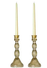 Glass candle holders with two ivory candles, ribbed column body and round base