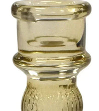 Close-up of amber glass candle holder top and ribbed neck, wide rim