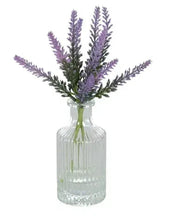 Artificial lavender flower stems in ribbed glass vase