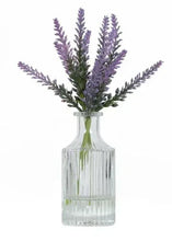 Artificial lavender flower stems in ribbed glass vase