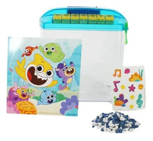 Educational betta fish tank with shark-themed stickers and bag of blue gravel