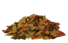 Goldfish food flakes in red, green, and tan pieces