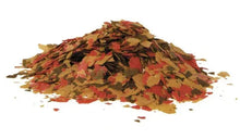 Tropical fish food flakes, red and yellow flake pile