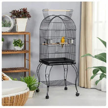 Black metal bird cage with open top on wheeled stand, interior perches and feeder bowls.
