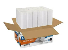 Open cardboard box of white C-fold paper towels with stacked packs inside