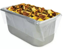 Ovenable pan liner in a deep baking pan with roasted food, clear liner and gray pan