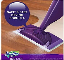Swiffer WetJet spray mop with purple cleaning pad on wooden floor, safe fast drying