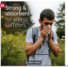 Kleenex Ultra Soft facial tissue held to nose by person