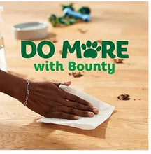 White paper towel sheet held by a hand on a countertop