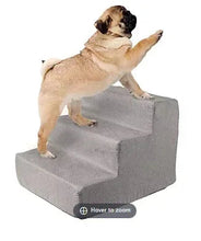 Gray three-step foam pet stairs with a dog standing on the top step
