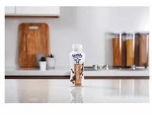 fairlife protein shake bottle in a clear glass, chocolate flavor